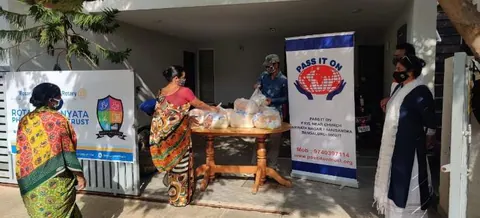 Volunteers handing out food kits at SRK Nagar